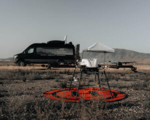 Photo of drone on landing page with control center van in the background